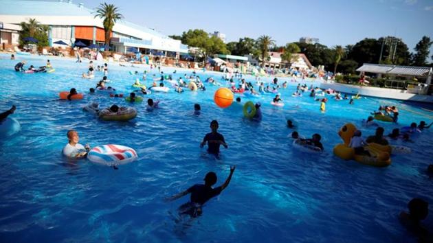 Visitors swim in a swimming pool, amid the coronavirus disease (COVID-19) outbreak, at Toshimaen amusement park which will close 94 years after it first opened with part of the site to be turned into a new Harry Potter theme park in 2023, in Tokyo, Japan August 11, 2020. (REUTERS/Issei Kato)