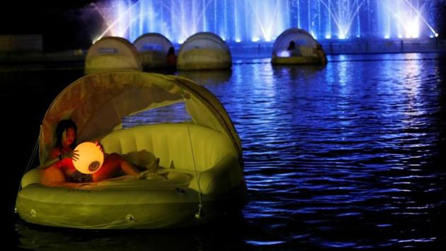 Visitors enjoy a swimming pool at night, amid the coronavirus disease (COVID-19) outbreak, at Toshimaen amusement park which will close 94 years after it first opened with part of the site to be turned into a new Harry Potter theme park in 2023, in Tokyo, Japan August 21, 2020. (REUTERS/Issei Kato)