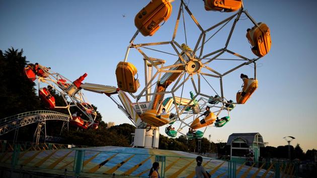 Visitors enjoy an attraction, amid the coronavirus disease (COVID-19) outbreak. (REUTERS/Issei Kato)