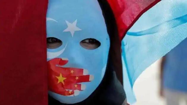 An ethnic Uighur demonstrator wears a mask as she attends a protest against China in front of the Chinese Consulate in Turkey(Reuters File Photo)