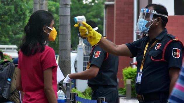 Security personnel doing sanitization and thermal check-up of students and examinees during the JEE examination at an exam center, in Kolkata on Wednesday. (ANI) Security personnel doing sanitization and thermal check-up of students and examinees during the JEE examination at an exam center, in Kolkata on Wednesday. (ANI)