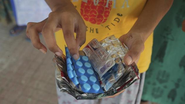 A woman checks preventive medicine for Covid-19 after collecting them from a government health centre in Hyderabad on August 31. Three states, Tamil Nadu, Uttar Pradesh and Maharashtra, account for nearly 34% of the total tests, according to the government. (Mahesh Kumar A. / AP) A woman checks preventive medicine for Covid-19 after collecting them from a government health centre in Hyderabad on August 31. Three states, Tamil Nadu, Uttar Pradesh and Maharashtra, account for nearly 34% of the total tests, according to the government. (Mahesh Kumar A. / AP)