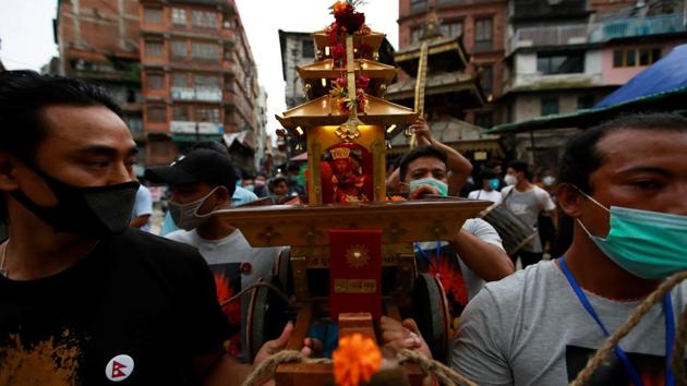 People carry the miniature chariot of the Living Goddess Kumari during the annual festival of Indra Jatra as official celebration has been cancelled due to the spread of the coronavirus disease (COVID-19) in Kathmandu, Nepal September 2, 2020. (REUTERS) People carry the miniature chariot of the Living Goddess Kumari during the annual festival of Indra Jatra as official celebration has been cancelled due to the spread of the coronavirus disease (COVID-19) in Kathmandu, Nepal September 2, 2020. (REUTERS)