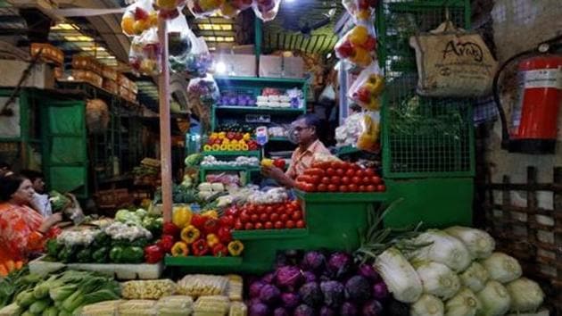 A vendor sells vegetables at a retail market in Kolkata. (REUTERS Photo) A vendor sells vegetables at a retail market in Kolkata. (REUTERS Photo)