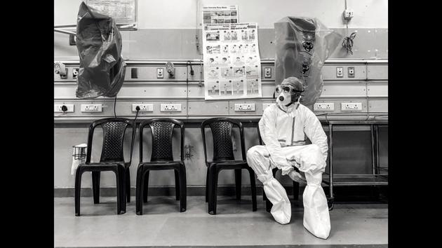 A doctor at All India Institute of Medical Sciences (AIIMS), takes a quick break to rest his feet before going back into the raging battles of the critical zone ward. (Parul Sharma)
