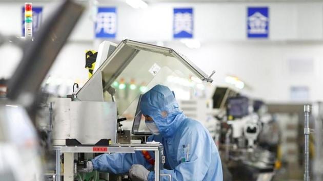An employee works at a factory of Renesas Semiconductor Co. during a government organised tour of the facility following the outbreak of the coronavirus disease, in Beijing, China. (REUTERS) An employee works at a factory of Renesas Semiconductor Co. during a government organised tour of the facility following the outbreak of the coronavirus disease, in Beijing, China. (REUTERS)