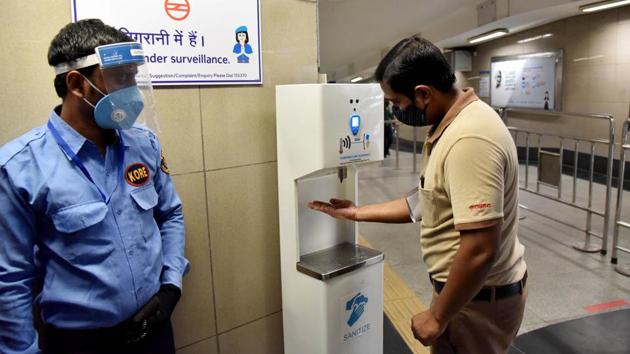 A DMRC employee dispenses hand sanitizer from a booth installed at Rajiv Chowk Metro Station in New Delhi on September 3. The SOP announced on September 2, specified that masks will be mandatory for all passengers entering the station, and only asymptomatic passengers will be allowed to travel. Masks will be available for purchase at kiosks in stations. (ANI) A DMRC employee dispenses hand sanitizer from a booth installed at Rajiv Chowk Metro Station in New Delhi on September 3. The SOP announced on September 2, specified that masks will be mandatory for all passengers entering the station, and only asymptomatic passengers will be allowed to travel. Masks will be available for purchase at kiosks in stations. (ANI)