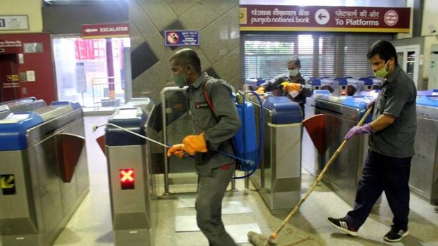 Delhi metro employees sanitize Huda City Center Metro Station in preparation of resumption of metro services for passengers amid coronavirus outbreak in Gurugram. (HT photo) Delhi metro employees sanitize Huda City Center Metro Station in preparation of resumption of metro services for passengers amid coronavirus outbreak in Gurugram. (HT photo)