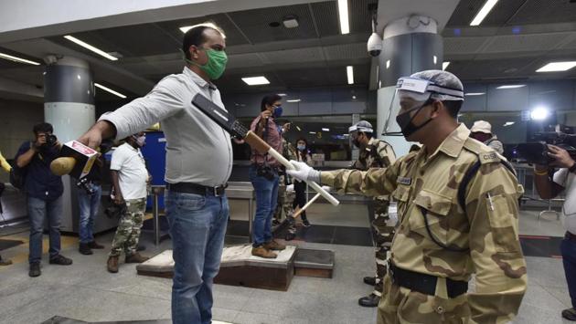 CISF personnel wearing face shields frisk people during a press preview to show the preparedness of Delhi Metro to resume service, at Rajiv Chowk Metro Station, in New Delhi on September 3. Use of tokens is barred and only smart cards will be allowed for trips. Top-up options will also be restricted to cashless modes for the time being, HT reported. (Sanjeev Verma / HT Photo) CISF personnel wearing face shields frisk people during a press preview to show the preparedness of Delhi Metro to resume service, at Rajiv Chowk Metro Station, in New Delhi on September 3. Use of tokens is barred and only smart cards will be allowed for trips. Top-up options will also be restricted to cashless modes for the time being, HT reported. (Sanjeev Verma / HT Photo)