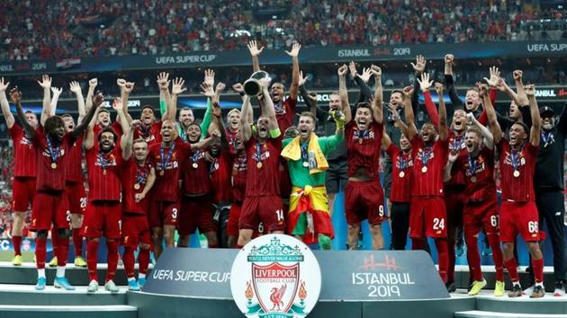 Liverpool's Jordan Henderson lifts the trophy as he celebrates winning the UEFA Super Cup with team(REUTERS)