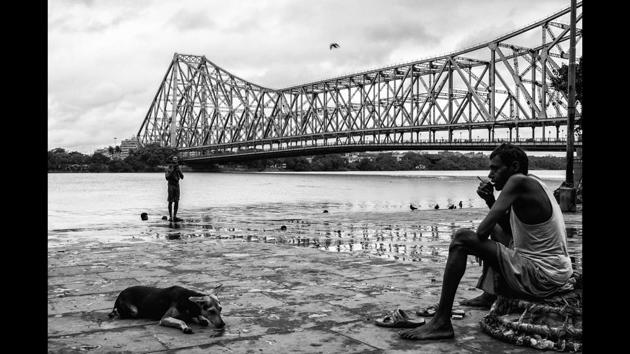 A porter rests by the ghat at the flower market in Kolkata. The flower market in the city is one of the largest flower markets in Asia. (Manjit Singh Hoonjan)