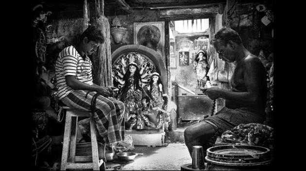 Idol makers at Kumortuli-- presumably the only neighbourhood of idol-makers in the world, braid jute hair to put finishing touches to idols just before the grand Durga Puja festival in Kolkata. (Manjit Singh Hoonjan)