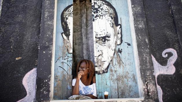 A woman looks from a window amid the new coronavirus pandemic at Morro da Providencia favela in Rio de Janeiro on September 3. Epidemiologists AFP spoke to warned that Brazil’s situation could suddenly worsen again if local and regional governments give in to pressure from business groups to reopen the economy too soon and if social distancing measures are abandoned. (Silvia Izquierdo / AP) A woman looks from a window amid the new coronavirus pandemic at Morro da Providencia favela in Rio de Janeiro on September 3. Epidemiologists AFP spoke to warned that Brazil’s situation could suddenly worsen again if local and regional governments give in to pressure from business groups to reopen the economy too soon and if social distancing measures are abandoned. (Silvia Izquierdo / AP)