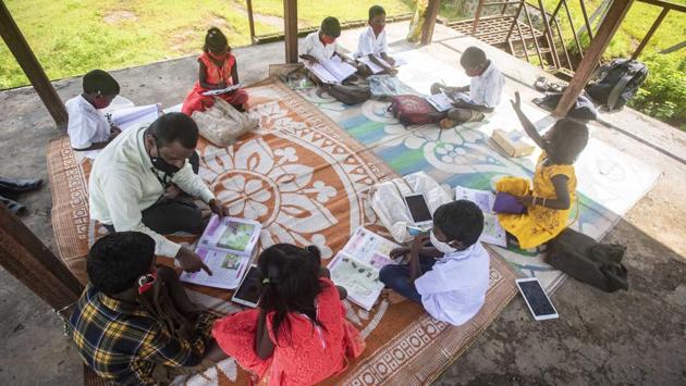 Sanjeev Bagul teaches his students during a class at Kalamshet village in Pune on September 4. Bagul, who came up with this idea of keeping his students connected with education amid the pandemic, has recently with the help of an NGO provided tablet phones to his students with educational apps installed in them. (Pratham Gokhale / HT Photo) 
