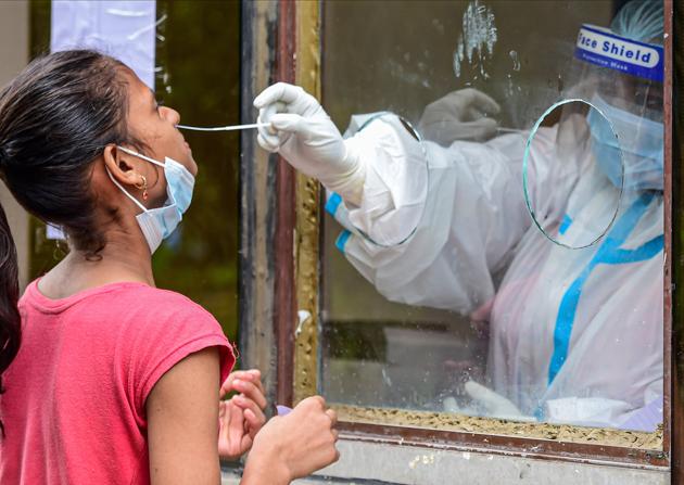 A medic collects a nasal sample from a girl for Covid-19 test at a centre in New Delhi on September 4.(PTI)