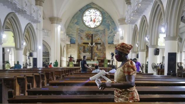 A church usher sprays disinfectant on pews to curb the spread of the coronavirus before a Sunday mass at the Holy Cross Cathedral in Lagos, Nigeria on August 30, 2020.(AP Photo) A church usher sprays disinfectant on pews to curb the spread of the coronavirus before a Sunday mass at the Holy Cross Cathedral in Lagos, Nigeria on August 30, 2020.(AP Photo)