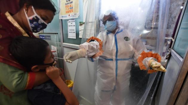 New Delhi, India - Sept. 3, 2020: A health worker behind a protective screen collects a swab sample from a child for coronavirus testing, at Shahdra Dispensary, in New Delhi, India, on Thursday, September 3, 2020. (Representational)(Raj K Raj/HT PHOTO) New Delhi, India - Sept. 3, 2020: A health worker behind a protective screen collects a swab sample from a child for coronavirus testing, at Shahdra Dispensary, in New Delhi, India, on Thursday, September 3, 2020. (Representational)(Raj K Raj/HT PHOTO)
