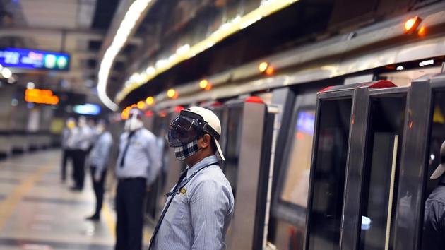 Security guards wearing face shields stands beside the metro train entrance during a press preview ahead of Delhi Metro Rail Corporation (DMRC)'s reopening of services for public on September 7, in New Delhi.(Raj K Raj/HT PHOTO)