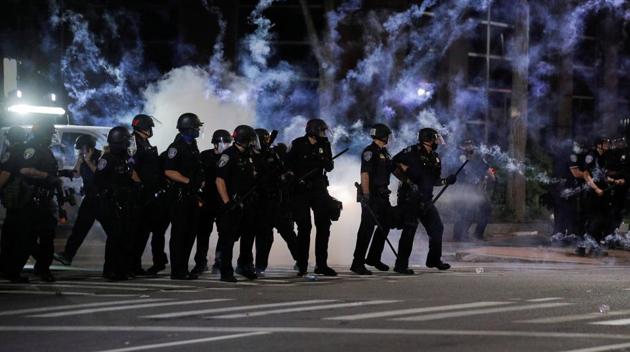 Police officers react after flares went off during a protest over the death of a Black man, Daniel Prude, after police put a spit hood over his head during an arrest on March 23, in Rochester, New York, U.S. September 4, 2020.(Reuters photo) Police officers react after flares went off during a protest over the death of a Black man, Daniel Prude, after police put a spit hood over his head during an arrest on March 23, in Rochester, New York, U.S. September 4, 2020.(Reuters photo)