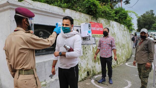 Pilgrims undergo thermal screening at Vaishno Devi temple. (PTI) Pilgrims undergo thermal screening at Vaishno Devi temple. (PTI)