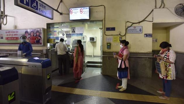 Passengers standing socially distanced at the token counter at a metro station in New Delhi on September 7. (Sanjeev Verma/HT)