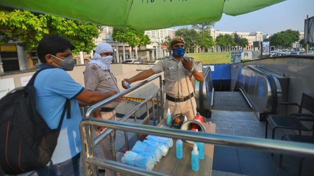 Masks and sanitisers are seen outside the metro station entry point. (Amal KS/HT)