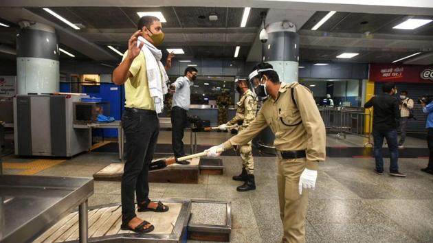 Passengers at security check point at a metro station. (Amal KS/HT)