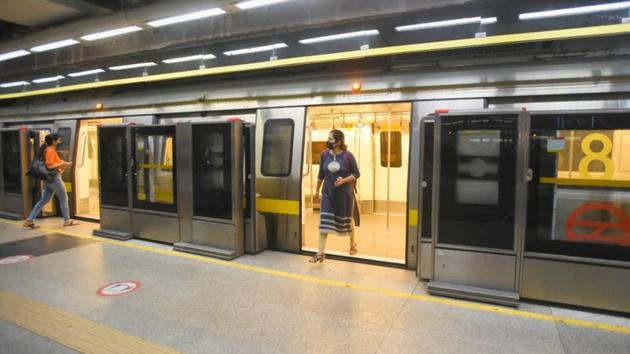 A passenger exits and another enters the Delhi Metro as services resume on September 7. (Amal KS/HT)