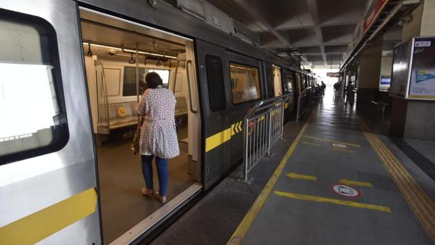 A lady boards the Yellow Line metro as DMRC resumes services after 169 days. (Sanjeev Verma/HT)