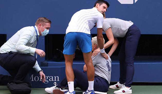 Djokovic immediately apologised and stood over her as she appeared in distress on the floor. (Getty) Djokovic immediately apologised and stood over her as she appeared in distress on the floor. (Getty)