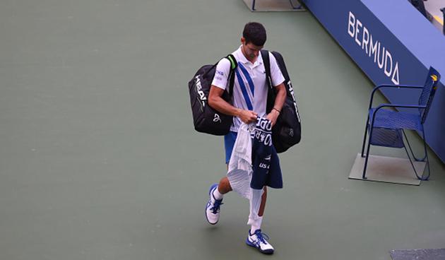 Despite his pleadings, Djokovic was eventually disqualified before walking over to shake hands with a stunned Carreno Busta and trudging off to face the music. (getty) Despite his pleadings, Djokovic was eventually disqualified before walking over to shake hands with a stunned Carreno Busta and trudging off to face the music. (getty)