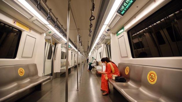 Commuters wearing masks sit in the allocated space in a metro coach in New Delhi on September 7. Stickers reading “Do not sit here” have been fixed on alternate seats to maintain social distancing inside the compartments. (Ajay Aggarwal / HT Photo)