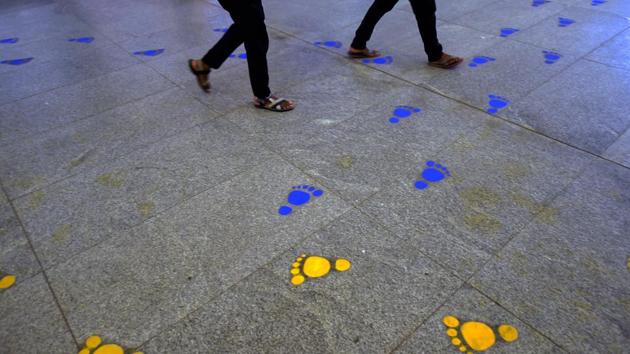 Markings on the floor to help passengers find their metro lines at Rajiv Chowk Metro Station in New Delhi on September 7. Extra staff has been deployed at stations, especially big ones such as Rajiv Chowk, to ensure commuters follow all the norms for safe travel. (Manvender Vashist / PTI)