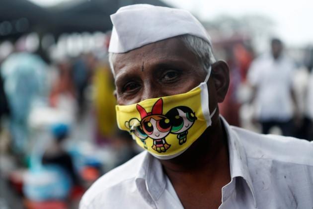 A fisherman wearing a protective face mask with characters from the American animated television series "The Powerpuff Girls" is seen at a fish market amidst the spread of the coronavirus disease (Covid-19) in Mumbai. (REUTERS) A fisherman wearing a protective face mask with characters from the American animated television series "The Powerpuff Girls" is seen at a fish market amidst the spread of the coronavirus disease (Covid-19) in Mumbai. (REUTERS)