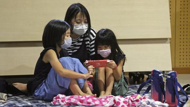 Local residents take refuge at an evacuation centre in Kagoshima, Japan on September 6. Authorities urged evacuations for people in areas across seven prefectures in southern Japan, public broadcaster NHK told Reuters. The process was complicated due to social distancing measures which meant that evacuation centres could take in fewer people than normal amid coronavirus concerns. (Kyodo via REUTERS) Local residents take refuge at an evacuation centre in Kagoshima, Japan on September 6. Authorities urged evacuations for people in areas across seven prefectures in southern Japan, public broadcaster NHK told Reuters. The process was complicated due to social distancing measures which meant that evacuation centres could take in fewer people than normal amid coronavirus concerns. (Kyodo via REUTERS)