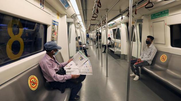 Passengers wearing protective masks travel on a Delhi Metro train in New Delhi on September 7. The return of the Delhi Metro, a public transport lifeline essential for the movement of the city’s workforce, comes as commercial activity opens up further with each phase of the Centre’s Unlock guidelines. (T. Narayan / Bloomberg)