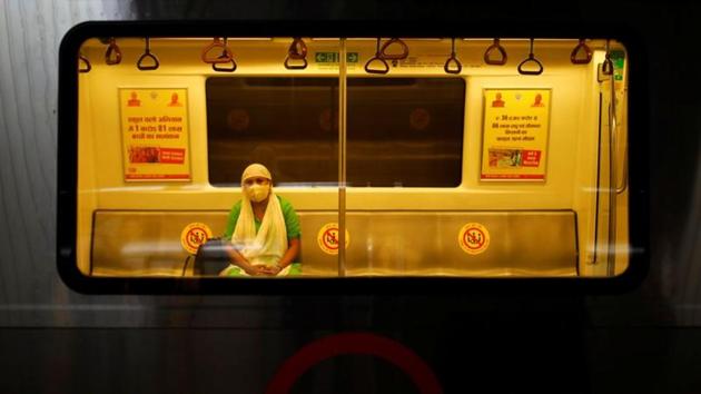 A woman wearing a face mask travels inside a Delhi metro train, on the first day of the restart of their operations, amidst the spread of coronavirus disease (COVID-19), in New Delhi.(REUTERS)
