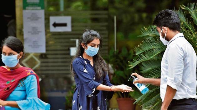 A student sanitises her hands during a DU entrance exam. (HT file photo) A student sanitises her hands during a DU entrance exam. (HT file photo)