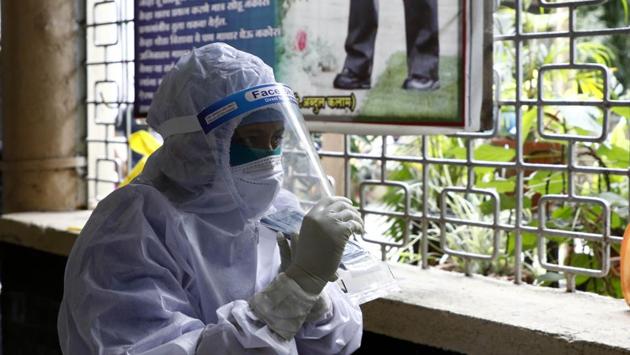 A health worker speaks on the phone during a swab collection drive in Pune on September 5. Over the last week, the positivity rate has been hovering around 24-25%, which stood at 28.23% on September 7, as 16,429 tested positive from 58,190 samples. (Rahul Raut / HT Photo)