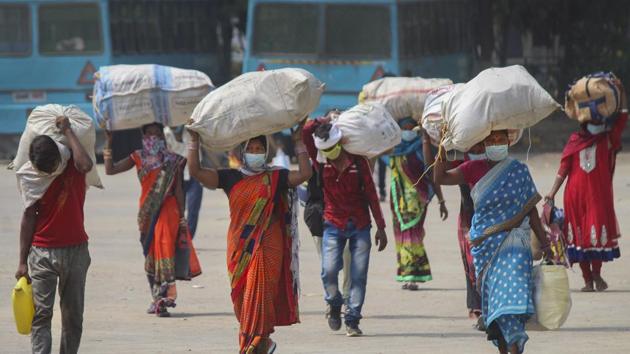 Migrants head to board buses at Tau Devi Lal Stadium, Gurugram, to reach the railway station for catching a Shramik Special train to Bilaspur, Chhattisgarh, in June this year. (PTI)