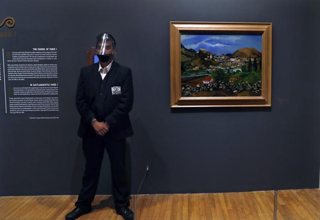 A museum guard stands next to a painting by Suzanne Valadon during the "El Paris de Modigliani y sus Contemporáneos" or The Paris of Modigliani and his contemporaries exhibit at the Palacio de Bellas Artes in Mexico City, Monday, Sept. 7, 2020. (AP) A museum guard stands next to a painting by Suzanne Valadon during the "El Paris de Modigliani y sus Contemporáneos" or The Paris of Modigliani and his contemporaries exhibit at the Palacio de Bellas Artes in Mexico City, Monday, Sept. 7, 2020. (AP)