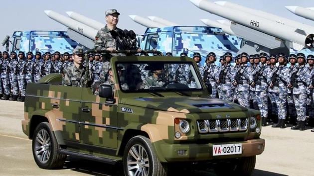 In this photo released by Xinhua News Agency, Chinese President Xi Jinping stands on a military jeep as he inspects troops of the People's Liberation Army during a military parade. (AP) In this photo released by Xinhua News Agency, Chinese President Xi Jinping stands on a military jeep as he inspects troops of the People's Liberation Army during a military parade. (AP)