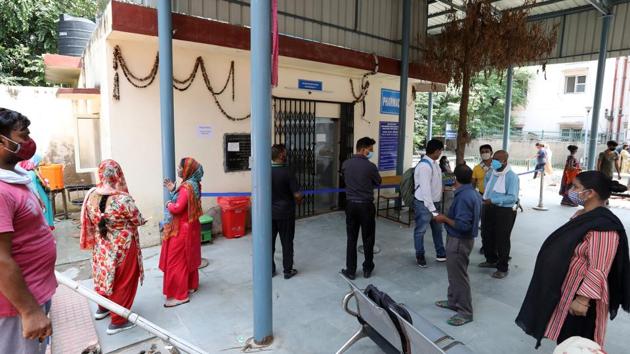People wearing protective masks and face coverings wait their turn to undergo Covid-19 testing at a government dispensary, in New Delhi on September 8. In addition to setting up testing camps at the city’s medical facilities, Delhi government has also used interstate bus terminals (ISBTs), railway stations, construction sites, weekly markets and some mohalla clinics to ramp up the testing numbers. (T. Narayan / Bloomberg) People wearing protective masks and face coverings wait their turn to undergo Covid-19 testing at a government dispensary, in New Delhi on September 8. In addition to setting up testing camps at the city’s medical facilities, Delhi government has also used interstate bus terminals (ISBTs), railway stations, construction sites, weekly markets and some mohalla clinics to ramp up the testing numbers. (T. Narayan / Bloomberg)