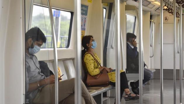Commuters in a metro train coach after services were resumed in New Delhi on September 7. Giving an insight into the rising cases in Delhi, a Delhi Disaster Management Authority (DDMA) official said that “Some probable reasons for the increase in positivity rate in Delhi could be lack of adherence to Covid-appropriate behaviour, the impact of festivals in August, late testing, cross-infection, the return of migrants and unlock measures.” (Sanjeev Verma / HT Photo) Commuters in a metro train coach after services were resumed in New Delhi on September 7. Giving an insight into the rising cases in Delhi, a Delhi Disaster Management Authority (DDMA) official said that “Some probable reasons for the increase in positivity rate in Delhi could be lack of adherence to Covid-appropriate behaviour, the impact of festivals in August, late testing, cross-infection, the return of migrants and unlock measures.” (Sanjeev Verma / HT Photo)