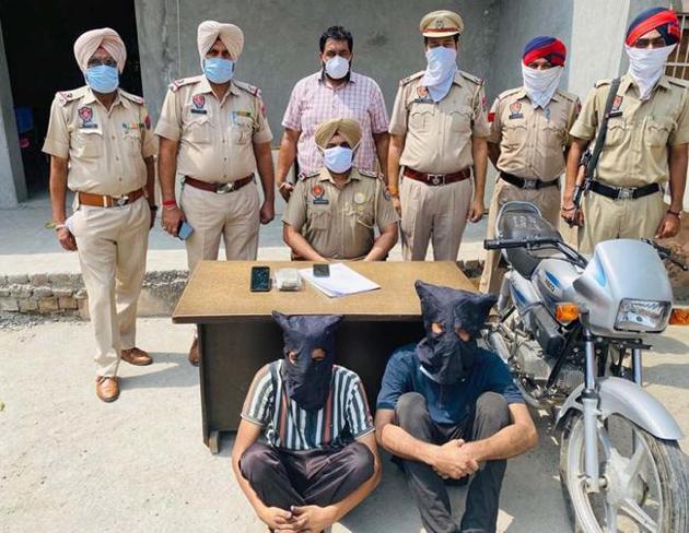 The two accused, including Arjinder Singh, who masterminded the robbery, in police custody in Ludhiana on Wednesday. (HT Photo) The two accused, including Arjinder Singh, who masterminded the robbery, in police custody in Ludhiana on Wednesday. (HT Photo)