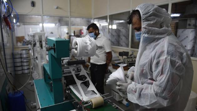 A worker (R) wearing PPE coveralls works on a N95 face mask assembly line on the outskirts of Ahmedabad on September 7. India overtook Brazil on September 7 as the country with the second highest number of confirmed coronavirus cases, even as key metro train lines reopened as part of efforts to boost the economy. (Sam Panthaky / AFP) A worker (R) wearing PPE coveralls works on a N95 face mask assembly line on the outskirts of Ahmedabad on September 7. India overtook Brazil on September 7 as the country with the second highest number of confirmed coronavirus cases, even as key metro train lines reopened as part of efforts to boost the economy. (Sam Panthaky / AFP)