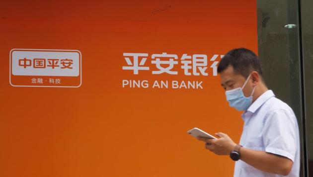 A man walks past a branch of Ping An Bank, a subsidiary of Ping An Insurance, in Beijing, China. (REUTERS) A man walks past a branch of Ping An Bank, a subsidiary of Ping An Insurance, in Beijing, China. (REUTERS)