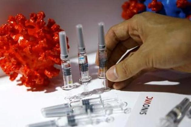 A staff member places a coronavirus vaccine candidate from Sinovac Biotech Ltd at its booth for display during the 2020 China International Fair for Trade in Services (CIFTIS) in Beijing in this file photo.(Reuters Photo)