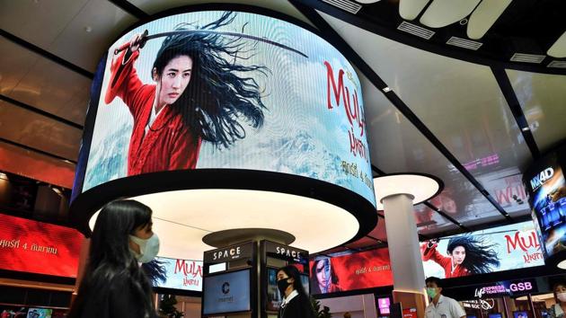 People walk past advertising displays for Disney’s Mulan film at a cinema inside a shopping mall in Bangkok.(AFP) People walk past advertising displays for Disney’s Mulan film at a cinema inside a shopping mall in Bangkok.(AFP)