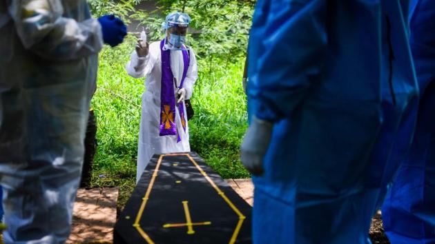 A pastor performs rites during the funeral of a Covid-19 victim at a cemetery in Pune on September 7. India’s current case count includes 73,890 deaths, of which 1,115 are from September 8. India is now recording the highest number of deaths from the disease in the world with more than 1,000 deaths reported daily for eight days straight. (Indranil Mukherjee / AFP) A pastor performs rites during the funeral of a Covid-19 victim at a cemetery in Pune on September 7. India’s current case count includes 73,890 deaths, of which 1,115 are from September 8. India is now recording the highest number of deaths from the disease in the world with more than 1,000 deaths reported daily for eight days straight. (Indranil Mukherjee / AFP)